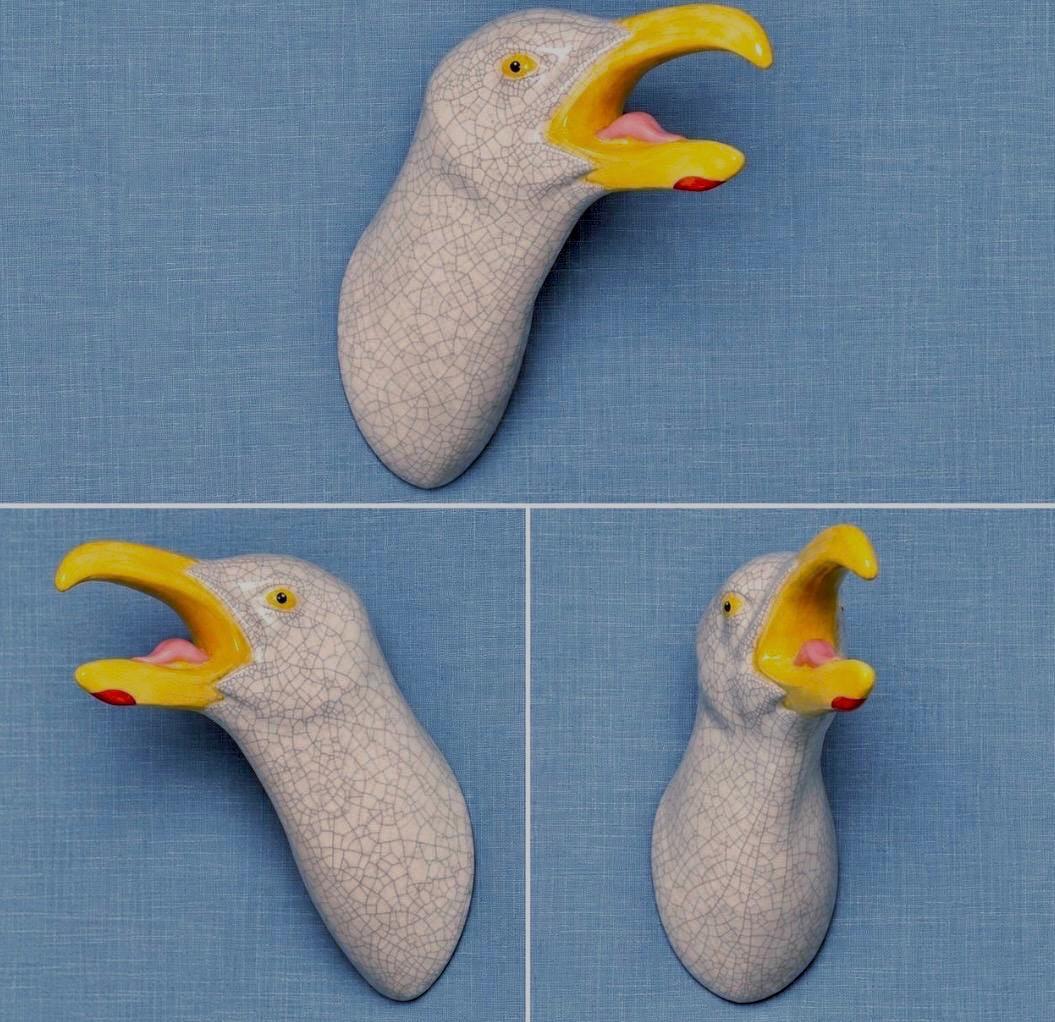 Three angles of handmade ceramic Squawking Seagull wall sculpture.