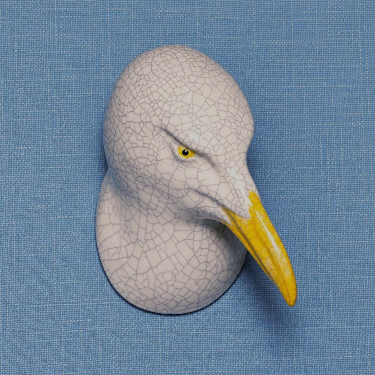 Front view of the left-leaning seagull, showing its handmade ceramic forms.