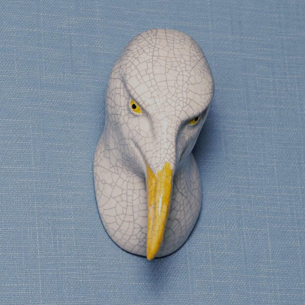 Side view of the left-leaning seagull, showing its handmade ceramic forms.