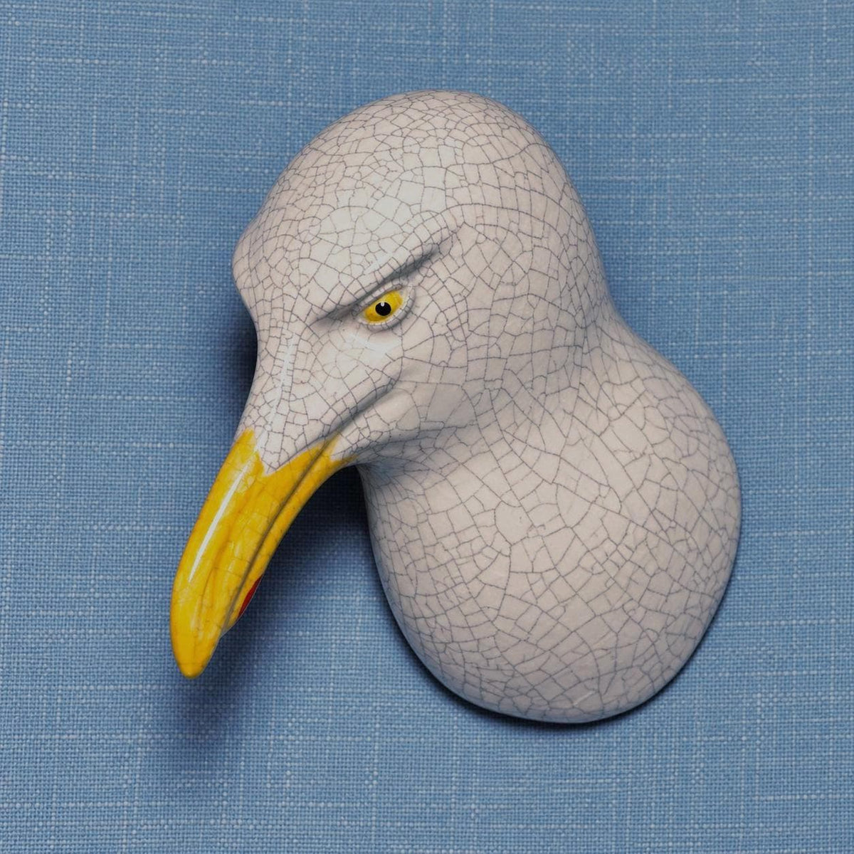 Front view of the right-leaning seagull, showing its handmade ceramic forms.