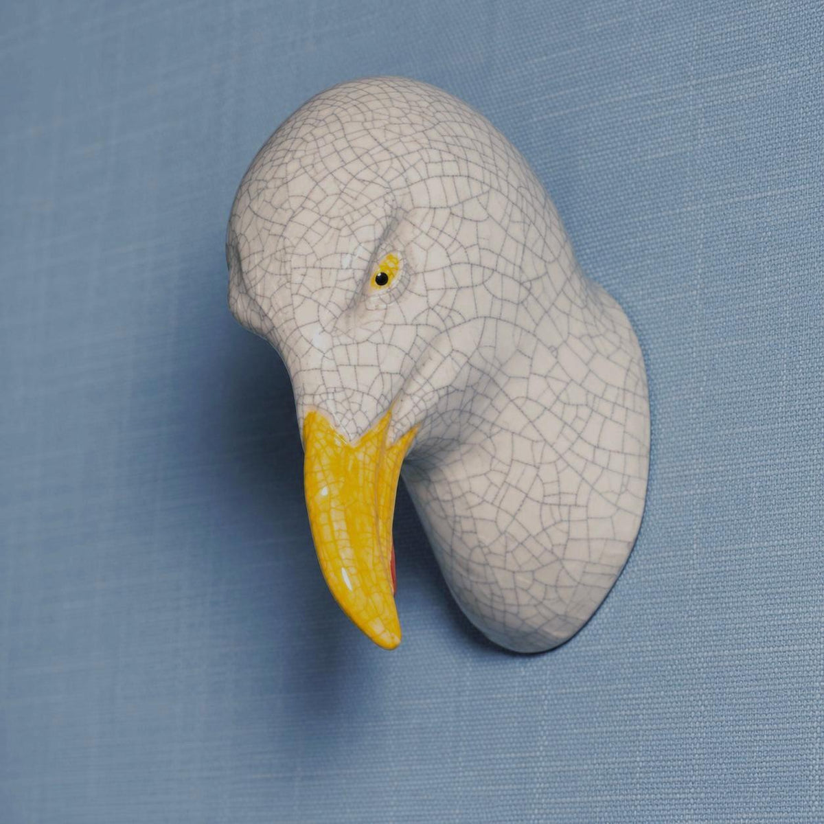 Side view of the left-leaning seagull, showing its handmade ceramic forms.
